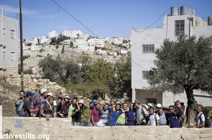 Young settlers singing hateful songs outside of Palestinian houses in Tel Rumeida, Hebron