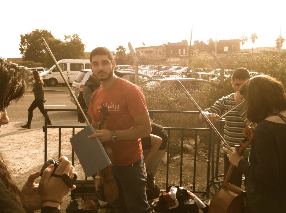Refusenik Omar Saad preparing to go to jail, choosing his viola over a rifle.  