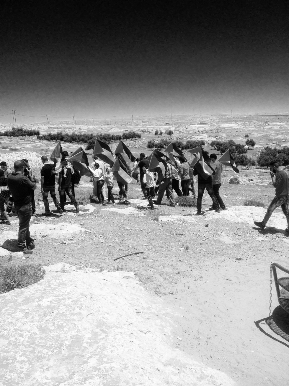The people of Susiya then began to march, holding Palestinian flags. 